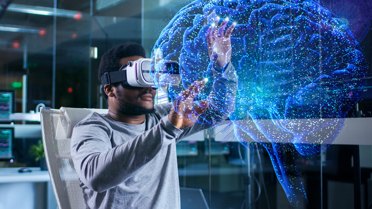 Student uses VR goggles and appears to be looking at a blue, 3D brain.