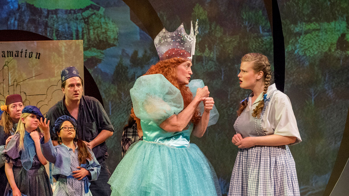 Students on a stage performing in The Wizard of Oz.