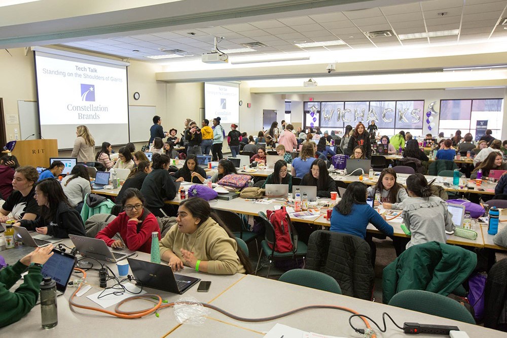 Room full of female high school and college students working on computers