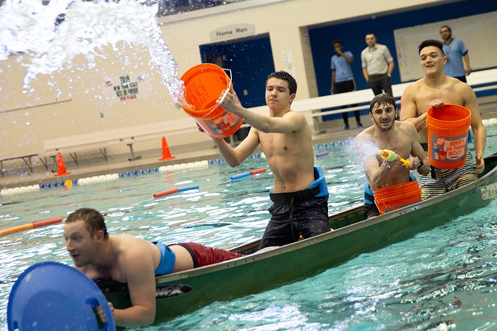 students in canoe in pool