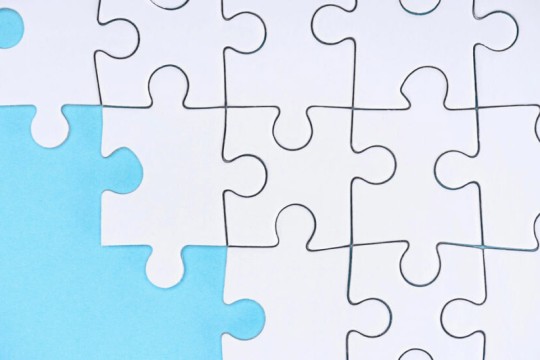 white puzzle pieces are shown in a light blue background.