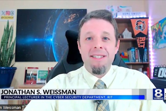 Jonathan Weissman appears on TV with a News 8 W R O C chryon.