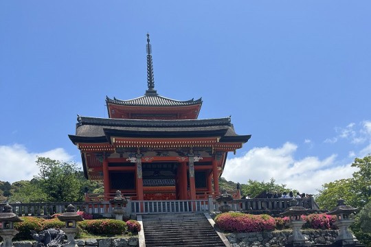 The Kiyomizudera Temple in Japan is shown against a blue sky.