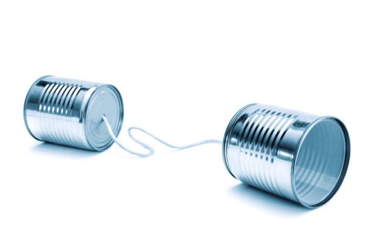 two tin cans are shown connected by a string on a white background.