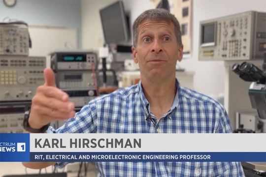 Karl Hirschman appears on screen to talk about semiconductor chip production.