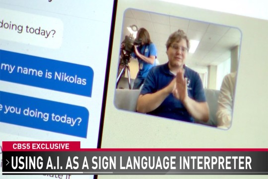 a phone screen is seen on the left side of the computer screen with a sign language interpreter on the right.