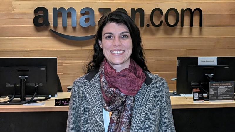 Gabriela Olinto standing in front of an Amazon.com sign