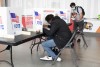 Two male students voting