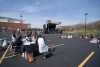 stage and tables set up in a parking lot.