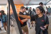 a student in a black shirt plays a Plinko game in the ROAR Rally tent.