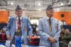 two elderly veterans stand in light blue suits at a veterans day breakfast at R I T.