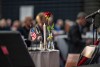 an arrangement of flowers in a clear vase sits on a table at the veterans day breakfast at R I T.