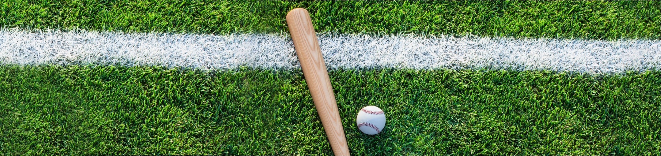 a baseball bat and ball on a field