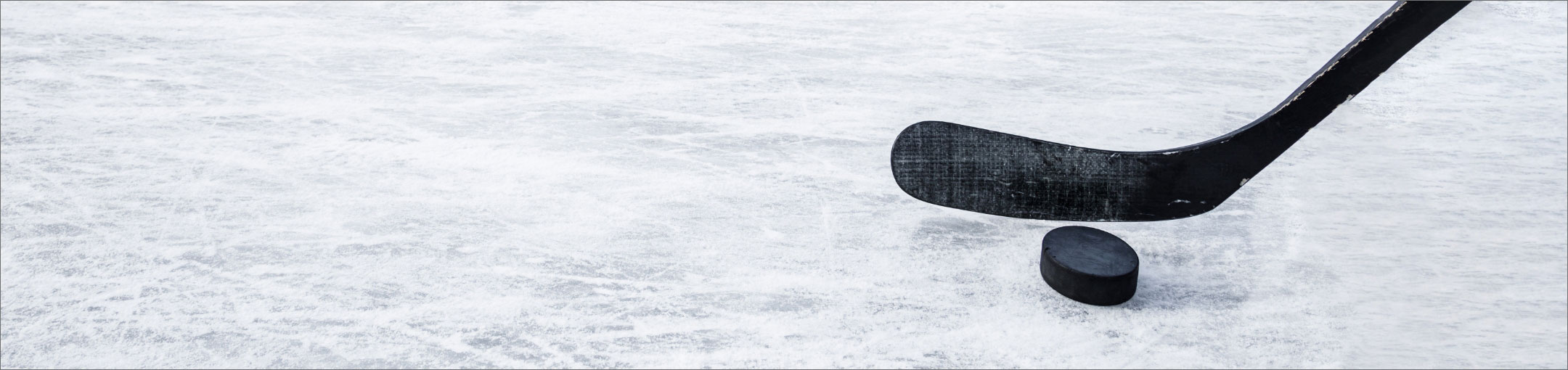 a hockey stick and puck on ice