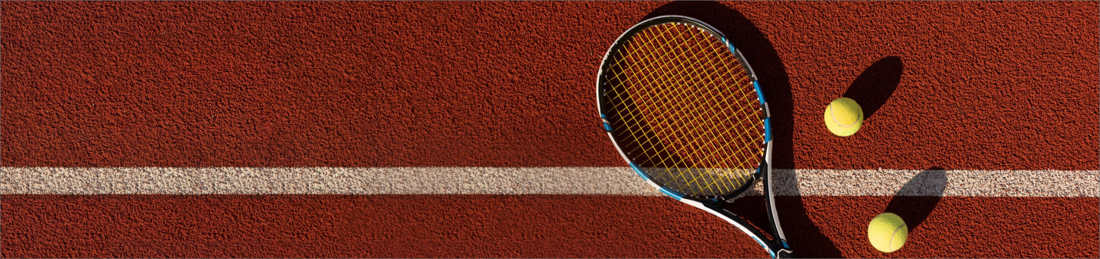 a tennis racquet and tennis balls on a court