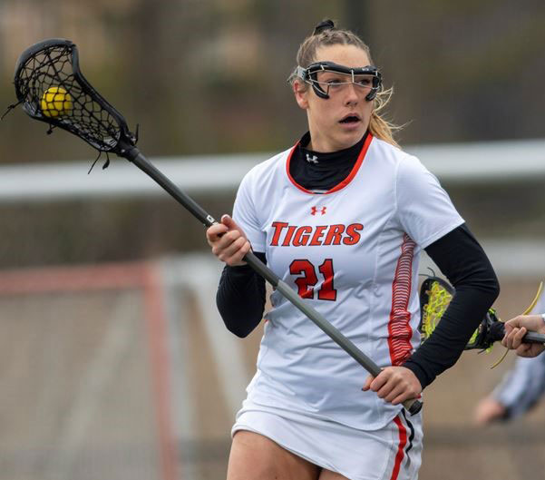 an RIT Lacrosse player running with the ball