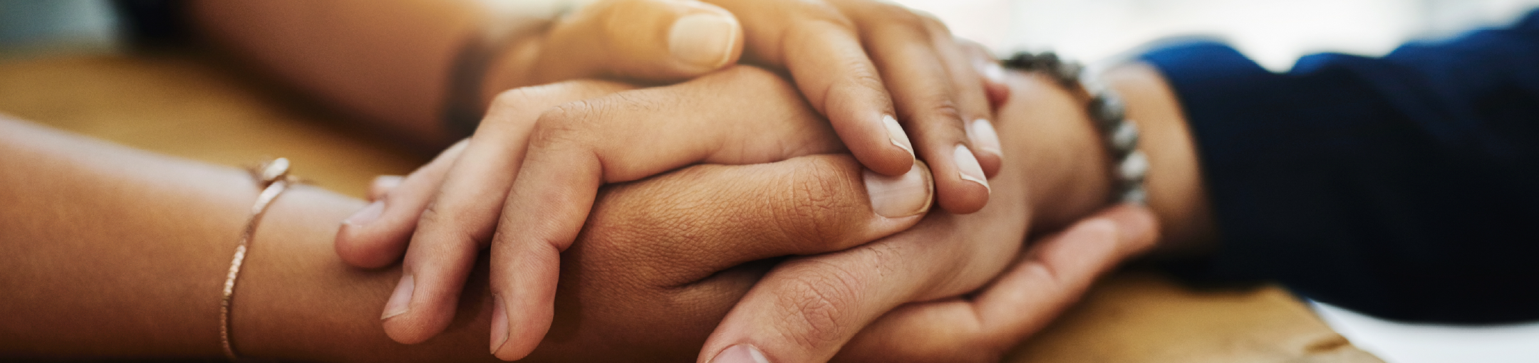 Two people holding hands in support