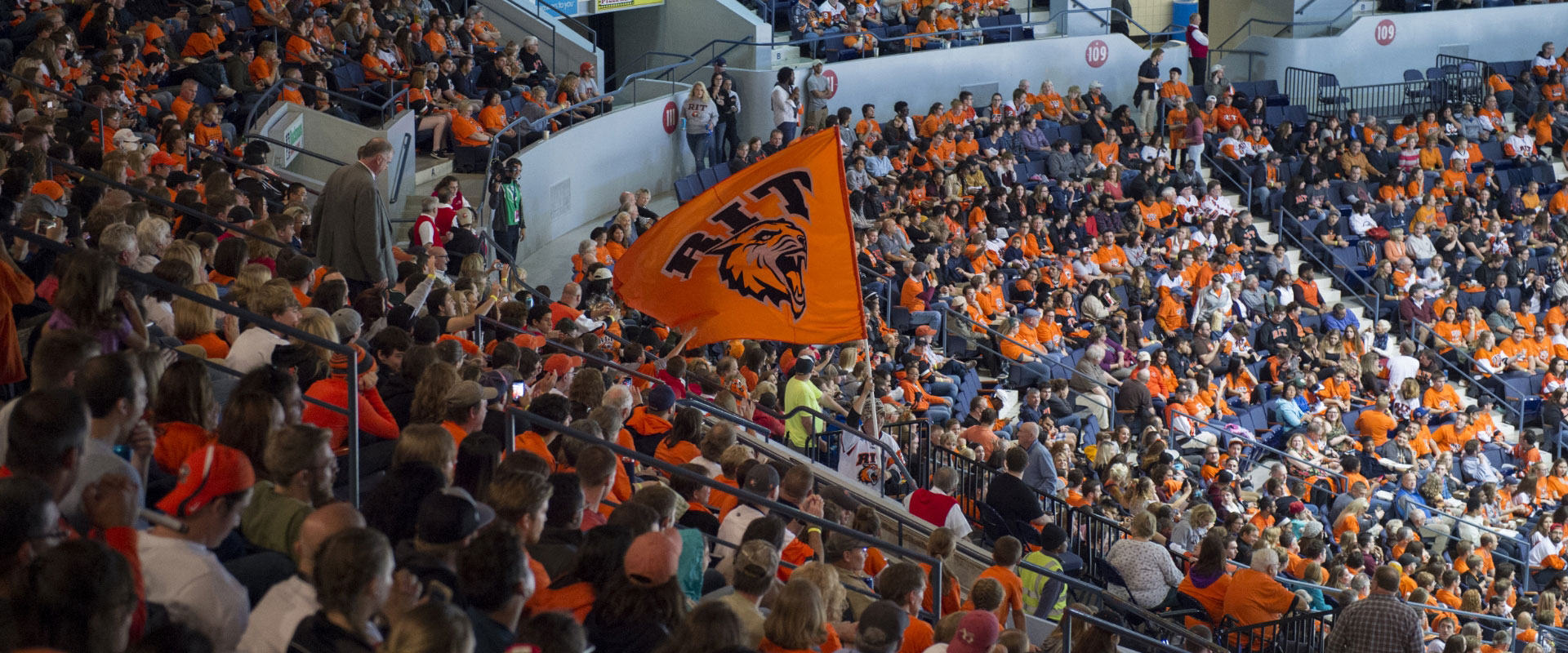 a large crowd seated at a stadium for brick city