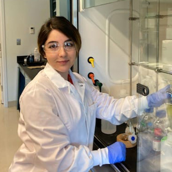 Nazanin Mosleh in a white lab coat posing for a picture