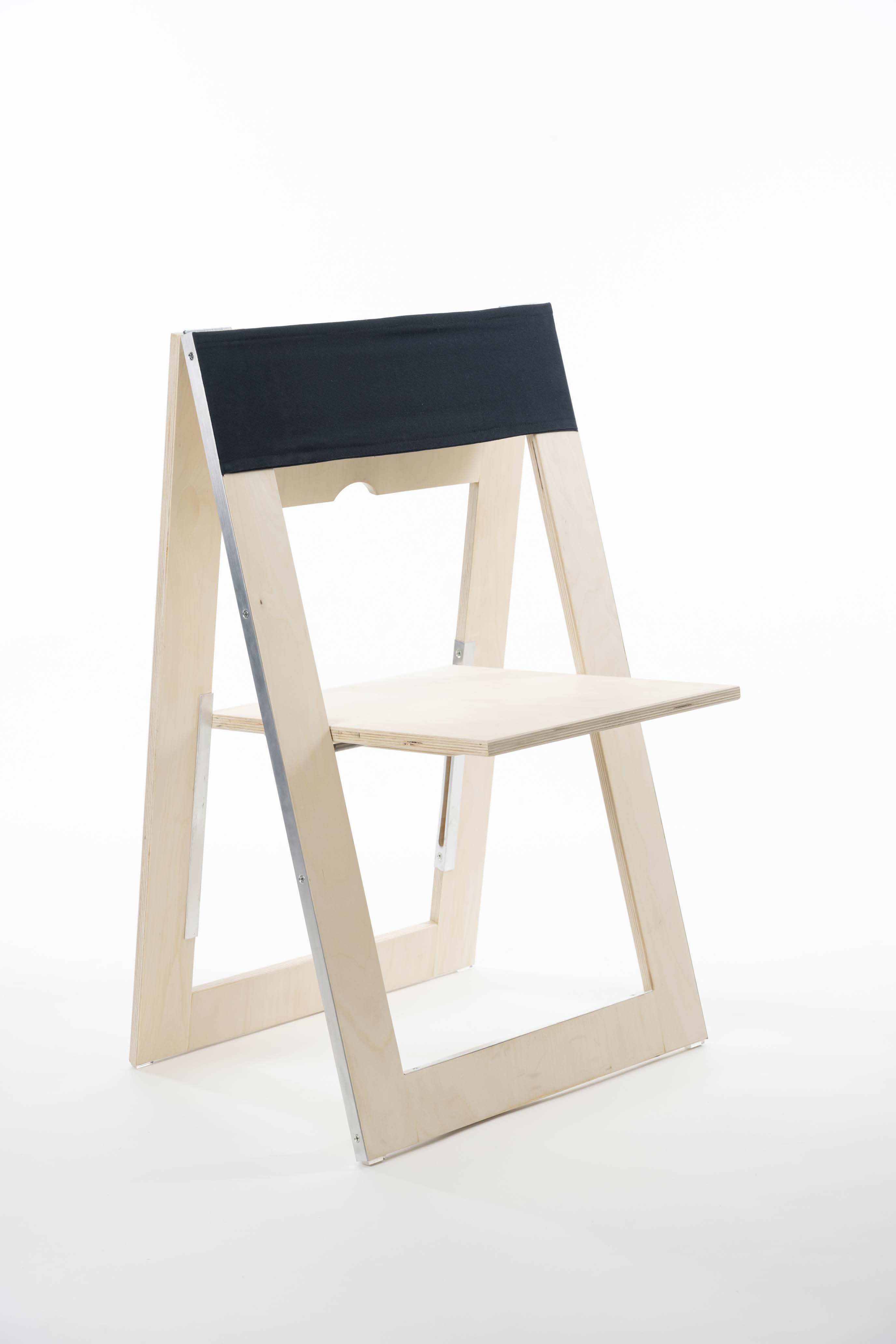 a view of a folding chair design with natural wood arms and legs and a black fabric back.